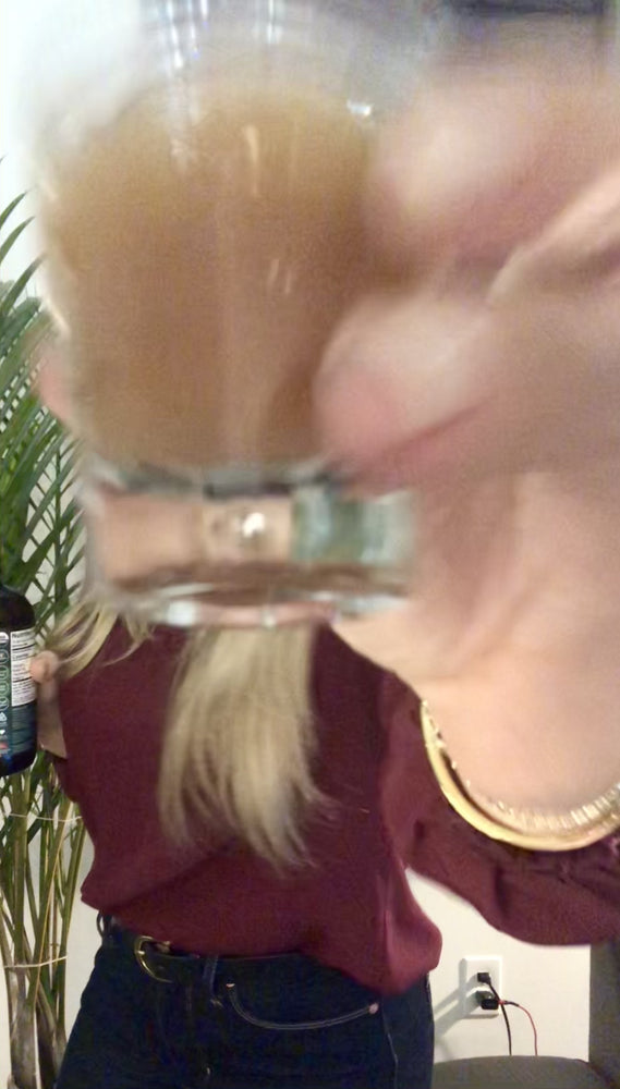 
                      
                        Load and play video in Gallery viewer, Woman taking a Woodroot Tonic shot to decrease inflammation in the gut and support overall gut health. 
                      
                    